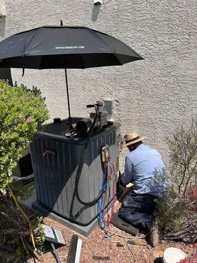 HVAC technician performing outdoor AC maintenance in Glenview
